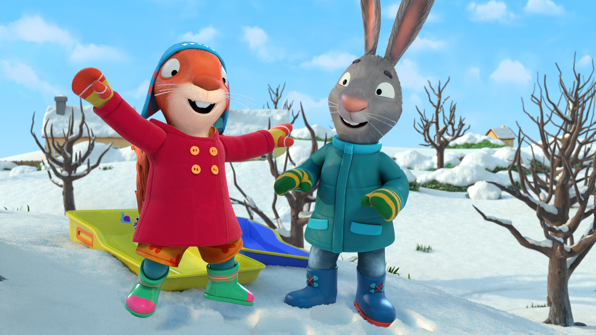 Jamila und Posy stehen vor ihren Schlitten. Jamila hat die Arme in die Luft geworfen.