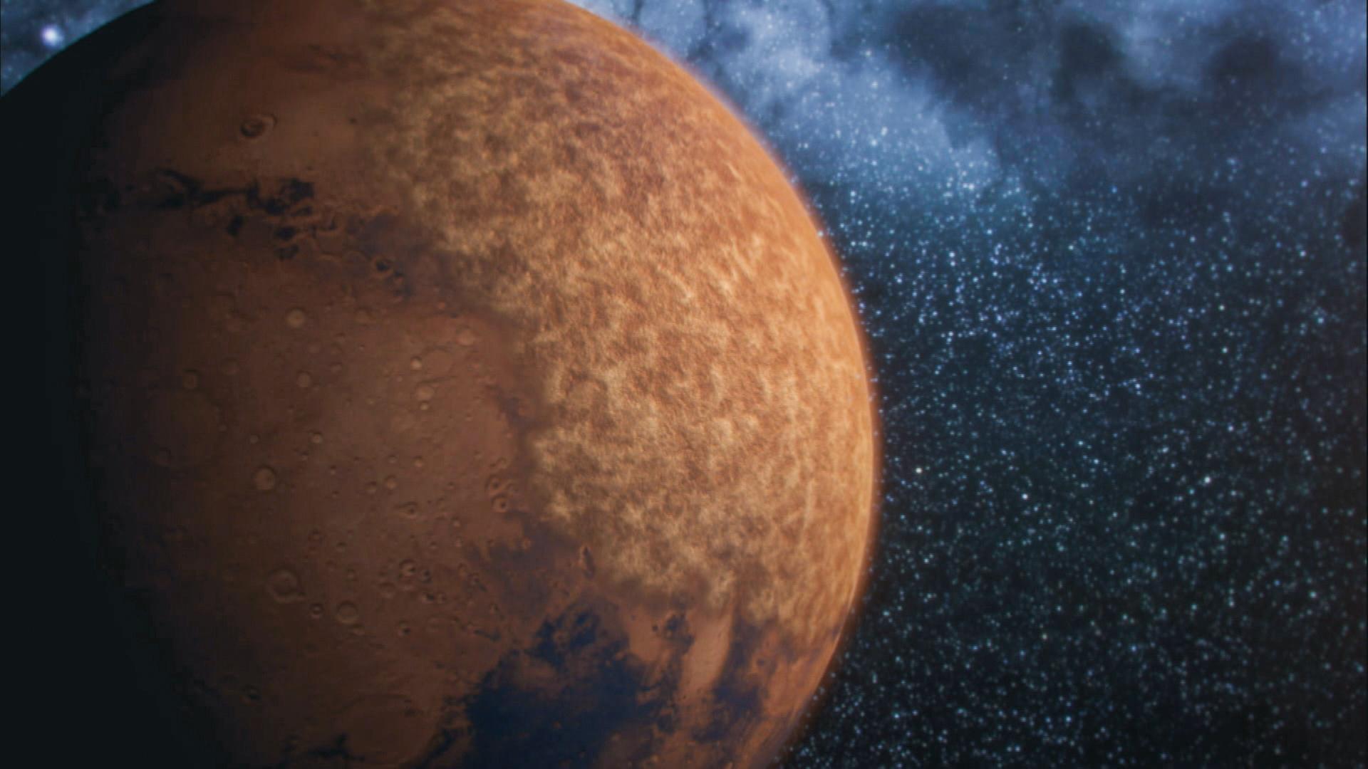  Computeranimation. Ein braun-rötlicher Planet ist vor dem Hintergrund bläulich schimmernder Sterne zu sehen.