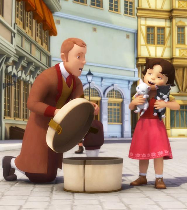 Heidi hält zwei Kätzchen im Arm. Auf ihrem rechten Arm eine weiße Katze und auf ihrem linken Arm ein schwarzes Kätzchen.