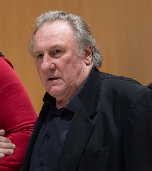 French actor Gerard Depardieu walks with his lawyer Jeremie Assous as he arrives for the opening of his trial in which he is accused of sexually abusing two women during a film shoot in 2021, at the Paris criminal court in the Tribunal de Paris courthouse, on March 27, 2025.