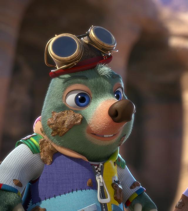 Moley steht neben Dotty. Beide sehen gut gelaunt aus und haben Schlammspritzer überall verteilt auf Gesicht und Kleidung.