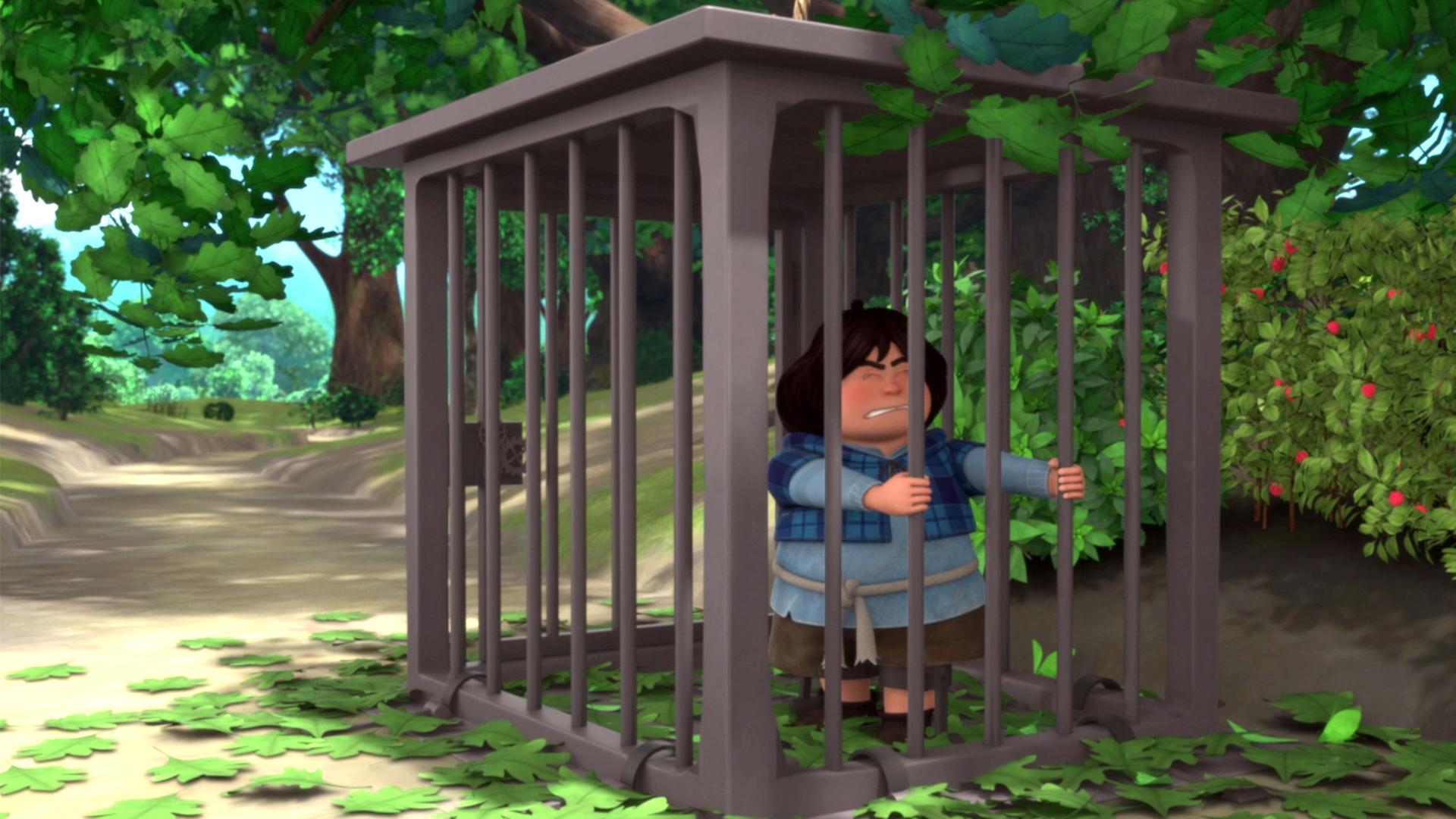 Tuck ist in einem großen, metallenen Käfig gefangen. Er rüttelt an den Stäben.