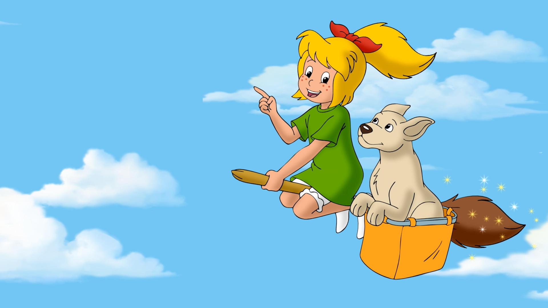 Bibi fliegt auf ihrem Besen durch die Luft. An der Seite des Besens hängt eine Kiste, in der eine Hündin sitzt. Ihre Ohren wehen im Wind.