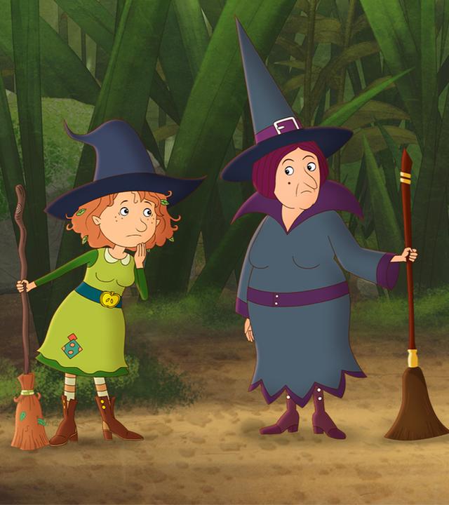 Oberhexe Pestilla steht mit ihrem kaputten Besen unglücklich neben Petronella und deren Besen, auf der anderen Seite stehen die Nachbars-Zwillinge Lea und Luis.