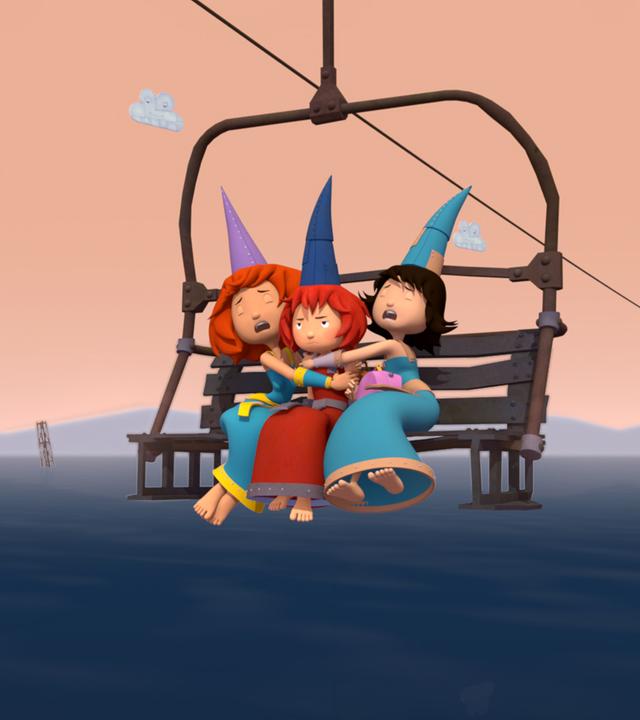 Drei Burgfräuleins sitzen im Sessellift fest und klammern sich an Bö, die in der Mitte sitzt.