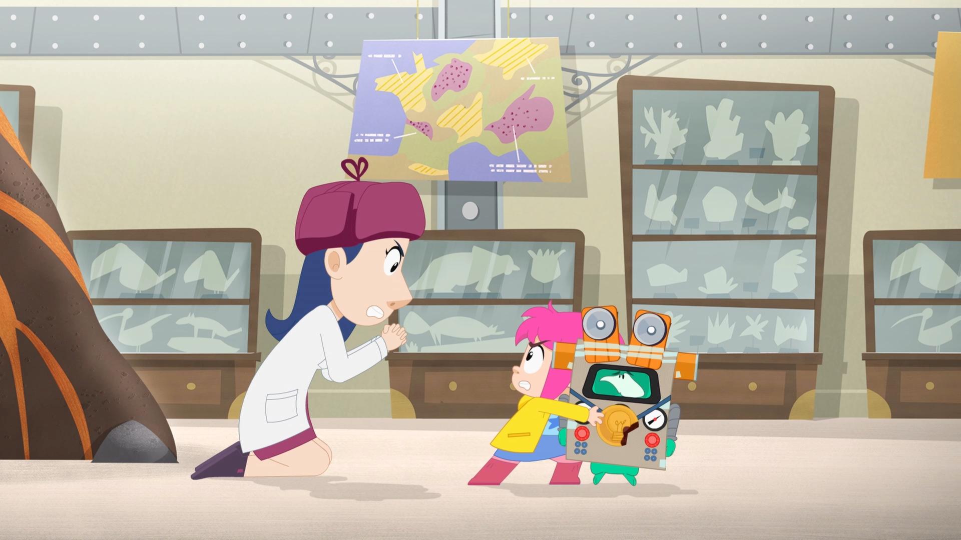 Eine Wissenschaftlerin bettelt Rebecca auf Knien an, den Roboter untersuchen zu dürfen. Ernest steht neben ihr. Er steckt in einem Pappkostüm und verfolgt die Aktion mit böser Miene.