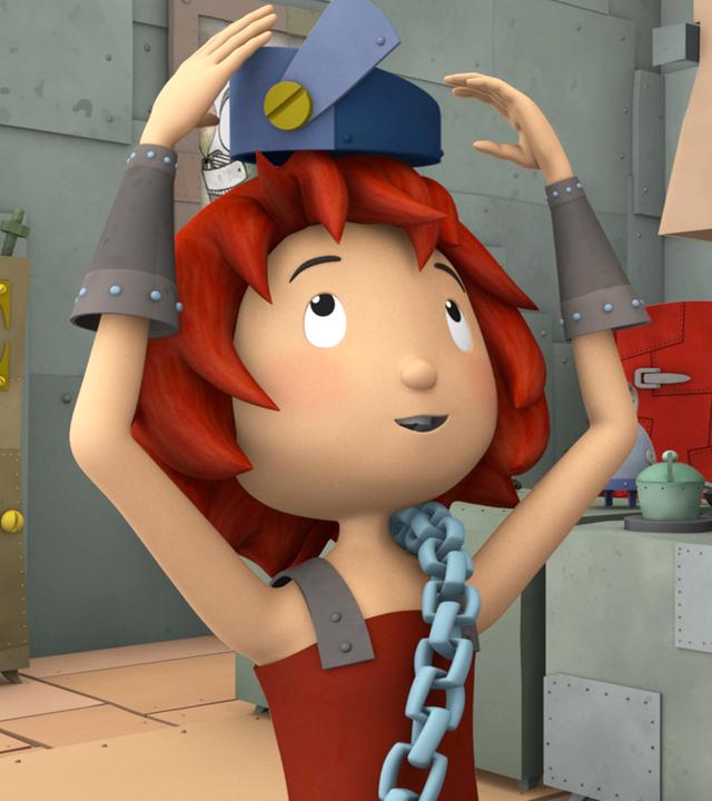 Bö trägt auf ihrem Kopf eine kuriose Kopfbedeckung, nach der sie mit ihren Händen tastet.