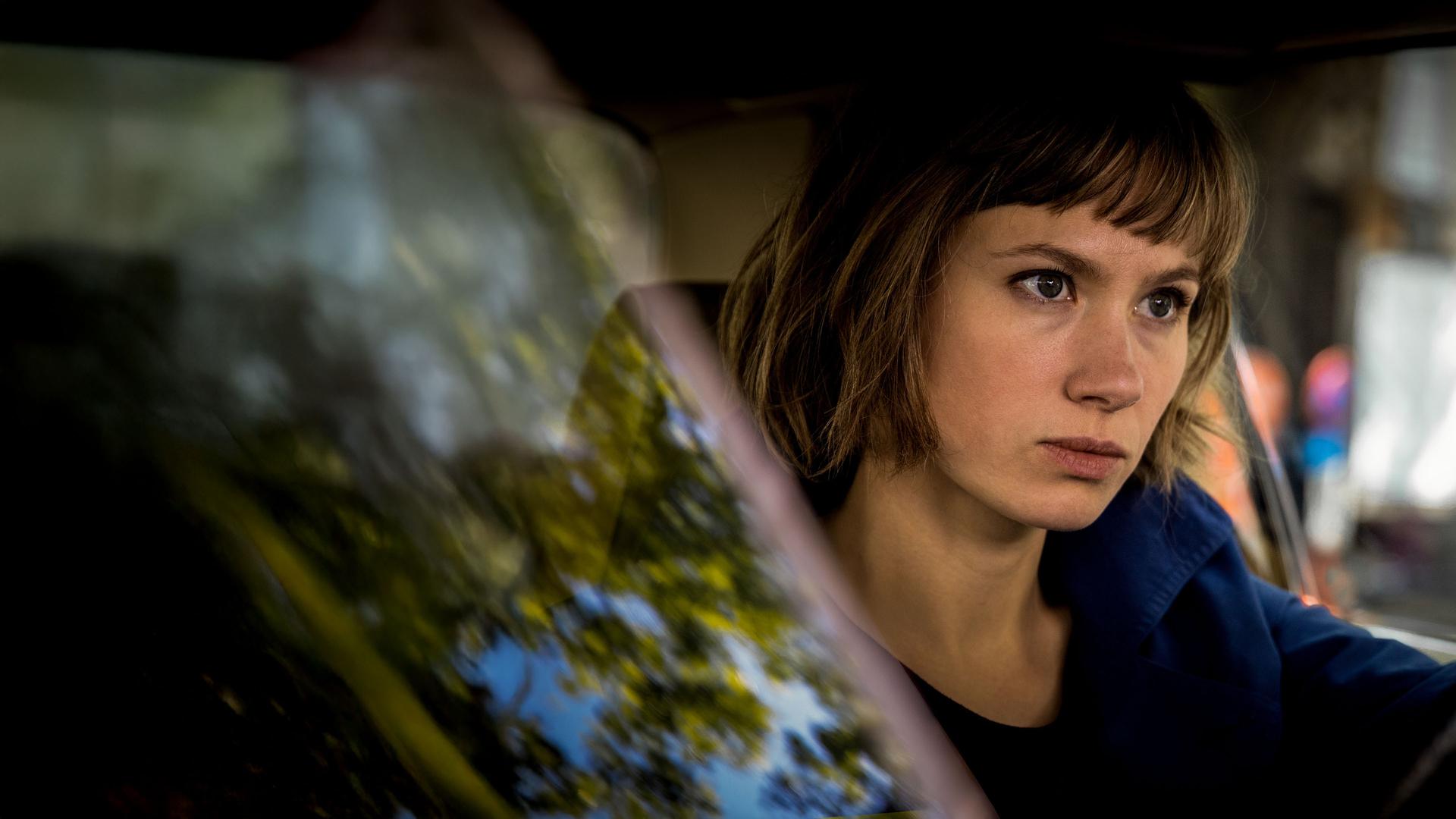 Doro Decker (Alina Levshin) sitzt im Auto auf dem Fahrersitz und schaut angespannt nach vorne.