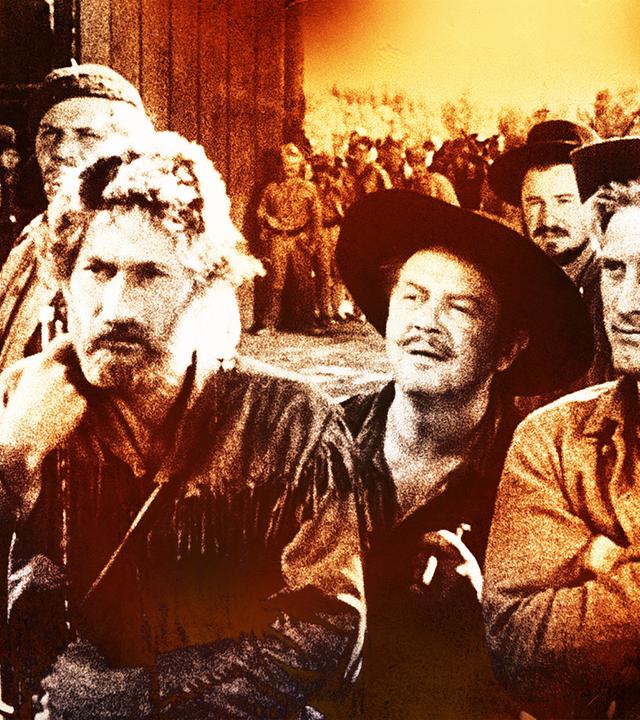 Mit anderen Männern steht der Trapper Jim Deakins (Kirk Douglas, vorne rechts) einem Mann mit Frack und Zylinder gegenüber. Im Hintergrund sind andere Männer und die Tore eines Forts zu sehen.