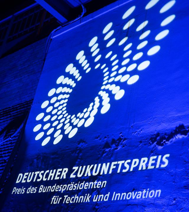 Das Logo des Deutschen Zukunftspreises wird an eine Wand projiziert.