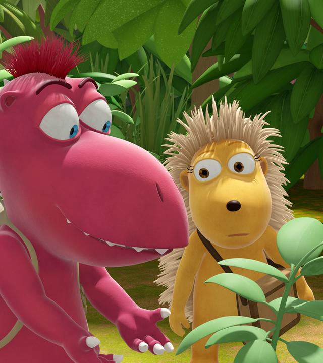 Oskar, Matilda und Kokosnuss stehen ratlos um eine grüne Pflanze herum. Kokosnuss kratzt sich am Kopf.