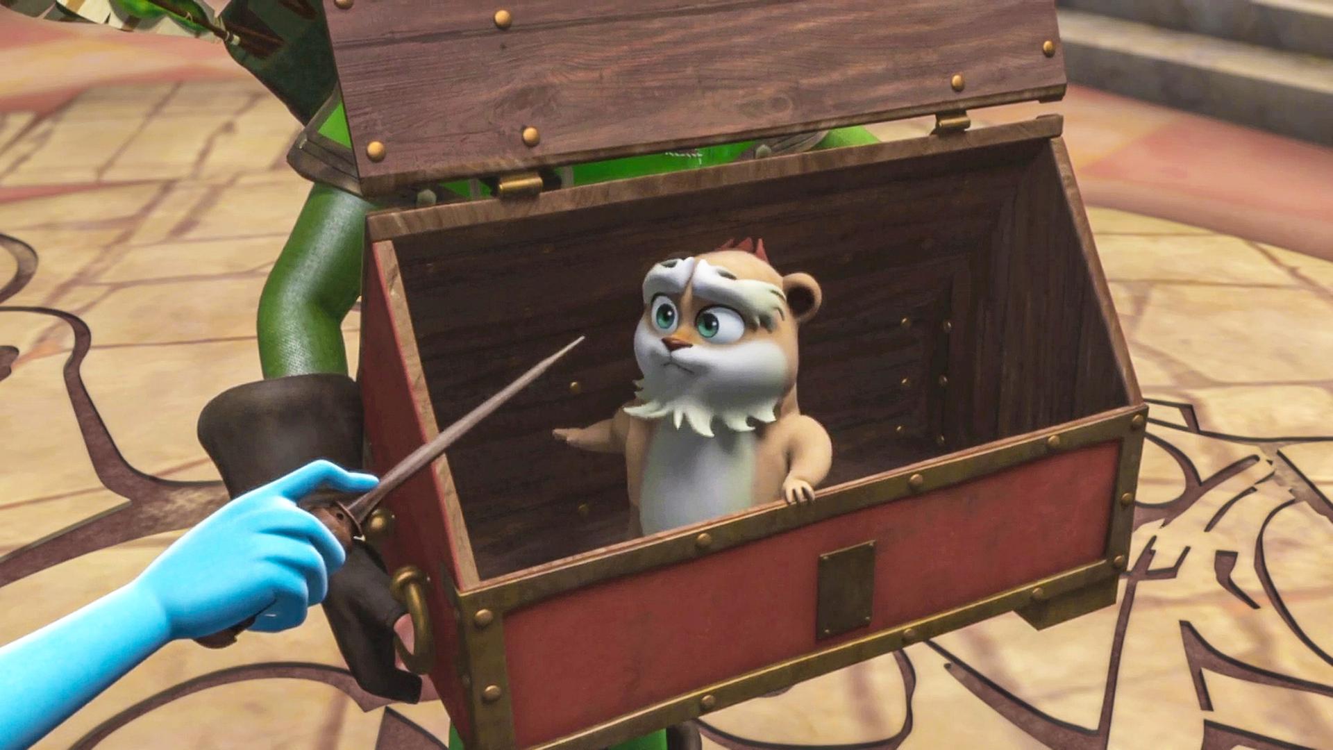 Der Hamster Derke sitzt in einer Truhe, während Marian ihren Zauberstab auf ihn richtet.