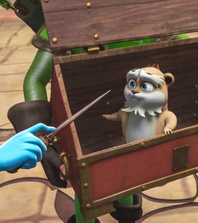 Der Hamster Derke sitzt in einer Truhe, während Marian ihren Zauberstab auf ihn richtet.