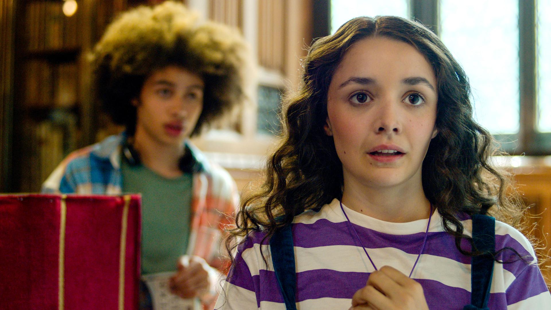 Frank und Addie sitzen in der Bibliothek. Addie hält verschreckt ihre Halskette fest.