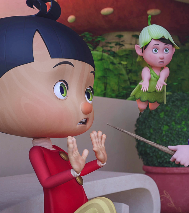 Betulla richtet wütend ihren Zauberstab gegen Pinocchio, der erschrocken die Hände hochhebt. Farfalla versucht zu vermitteln.