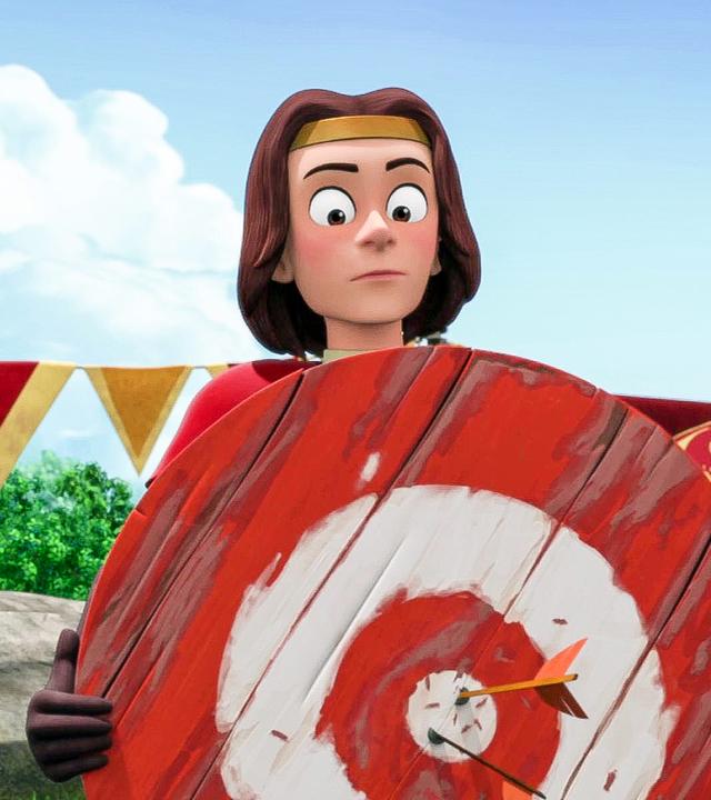 König Richard hält eine Zielscheibe aus Holz in den Händen. In der Mitte stecken zwei Pfeile. Er sieht überrascht aus.