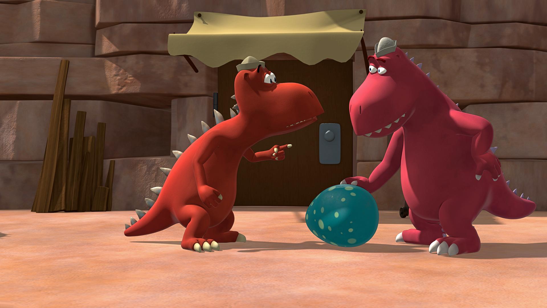 Zwei rote Fressdrachen finden ein riesiges blaues Ei mit weißen Punkten.