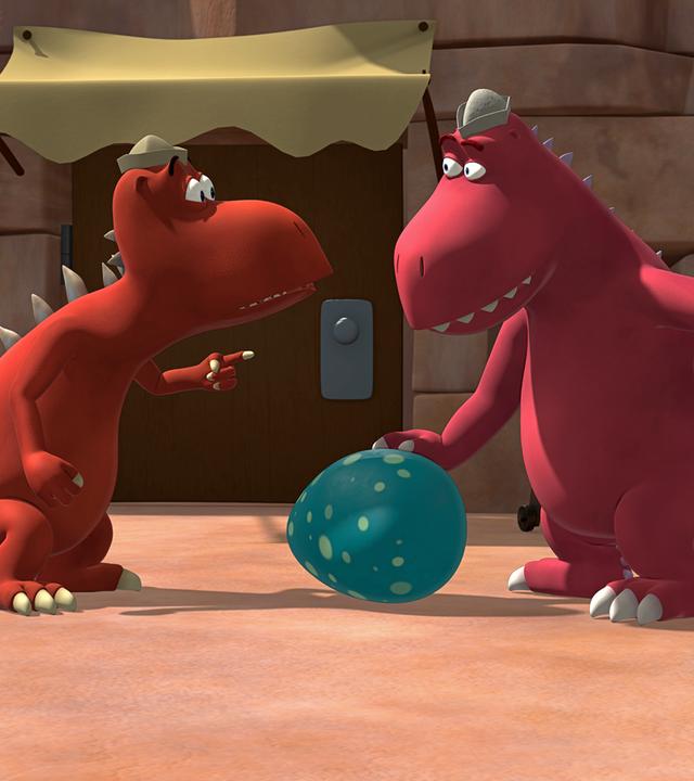 Zwei rote Fressdrachen finden ein riesiges blaues Ei mit weißen Punkten.