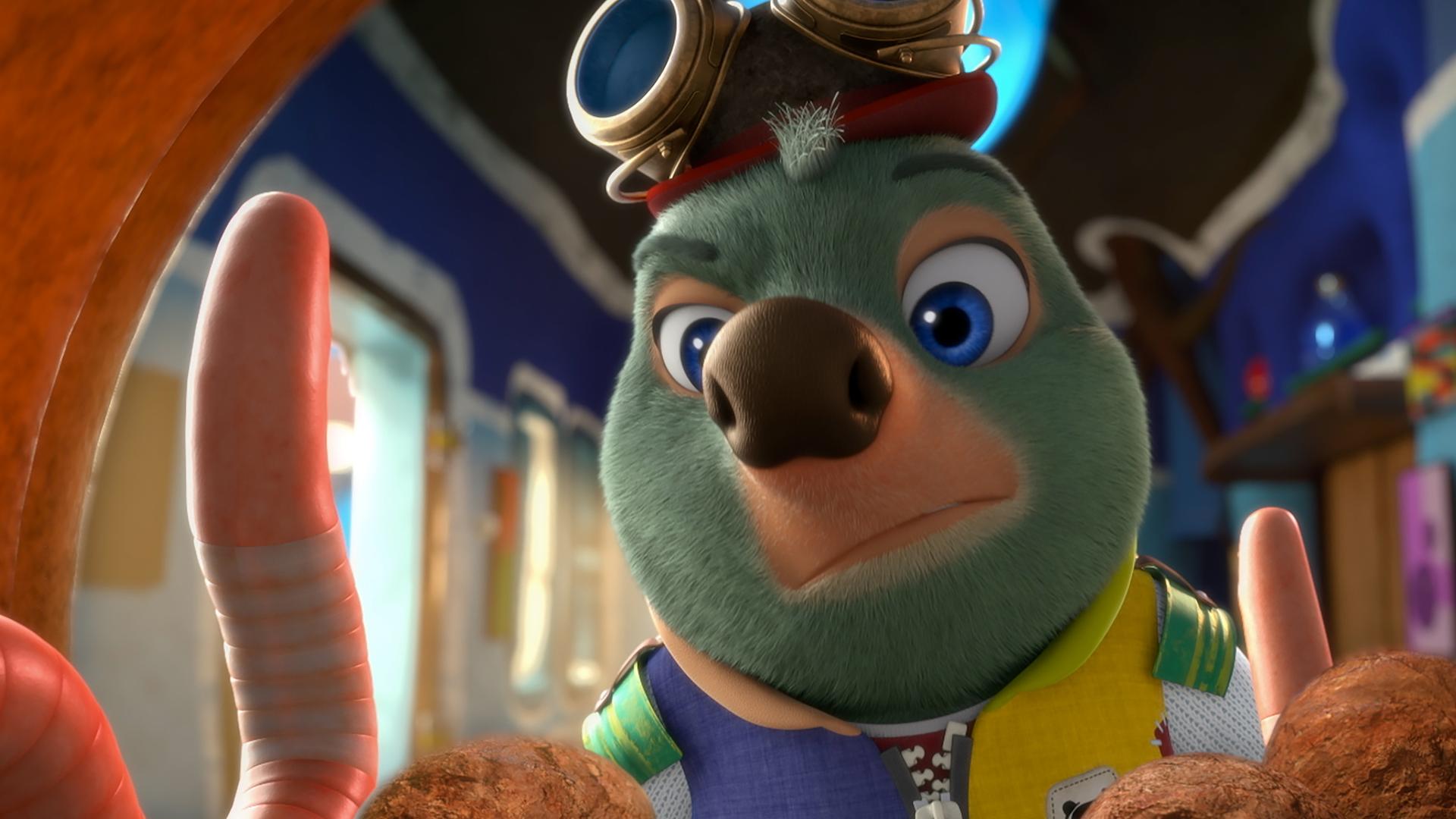 Moley steht wenig begeistert vor zwei aufgerichteten Würmern, die sich in einer Art Wurmkuschelhäuschen befinden.