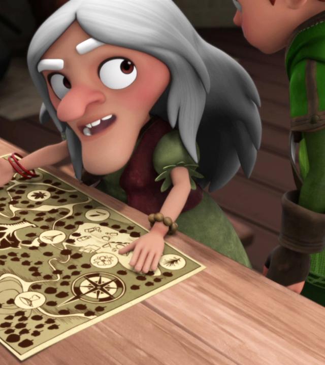 Die Kräuterfrau (links) breitet auf einem Tisch eine Karte von Sherwood aus. Robin (rechts) steht neben ihr und schaut sich die Karte an.