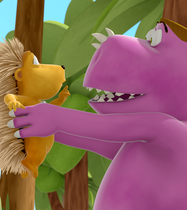 Fressdrache Dirk hält Matilda mit seinen Händen hoch.