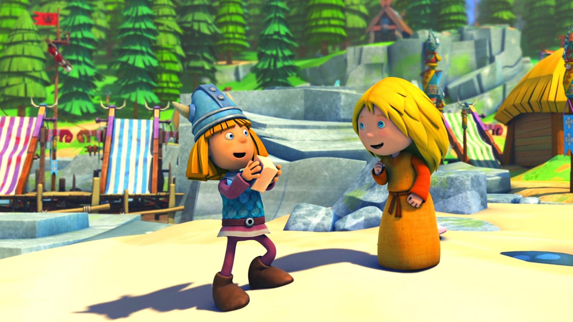 Wickie steht auf einem Platz im Dorf, er hat ein Stück Seife in der Hand. Ilvy steht rechts neben ihm. Beide sehen fröhlich aus.