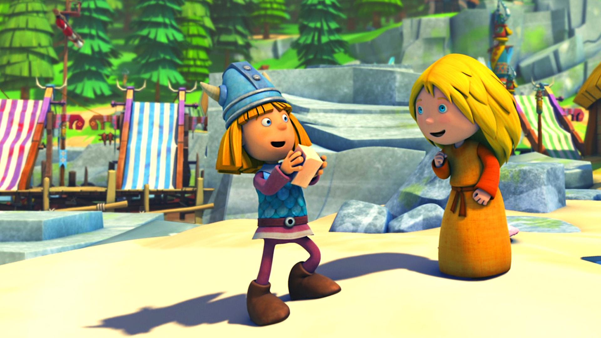 Wickie steht auf einem Platz im Dorf, er hat ein Stück Seife in der Hand. Ilvy steht rechts neben ihm. Beide sehen fröhlich aus.