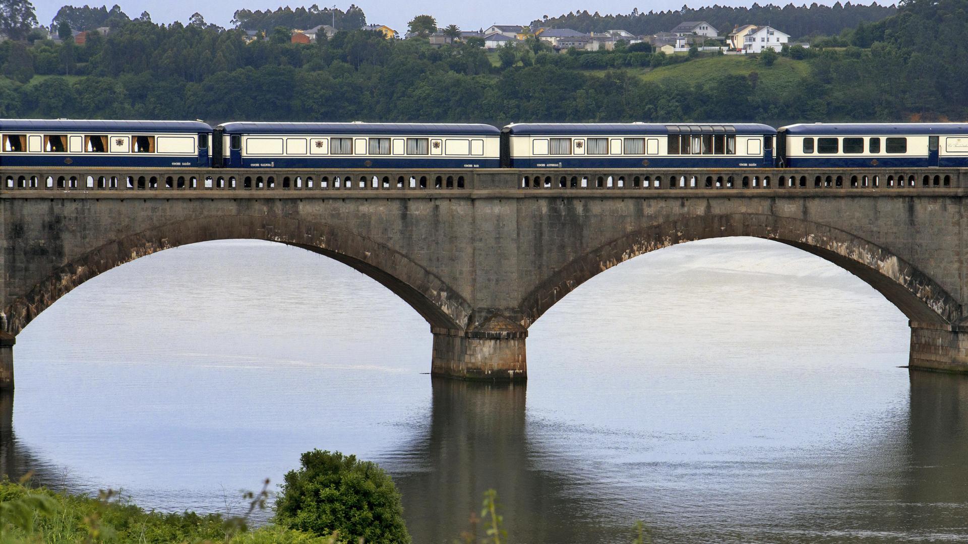 Ein Reisezug fährt über einen Fluss