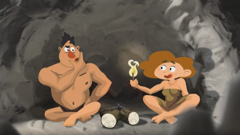 Zwei Steinzeitmenschen sitzen in einer Höhle und entzünden ein Feuer.