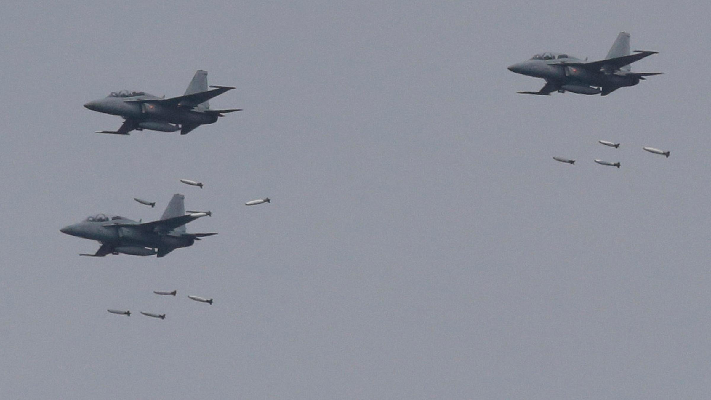 Südkoreanische FA-50 Kampfflugzeuge, die Bomben abwerfen.