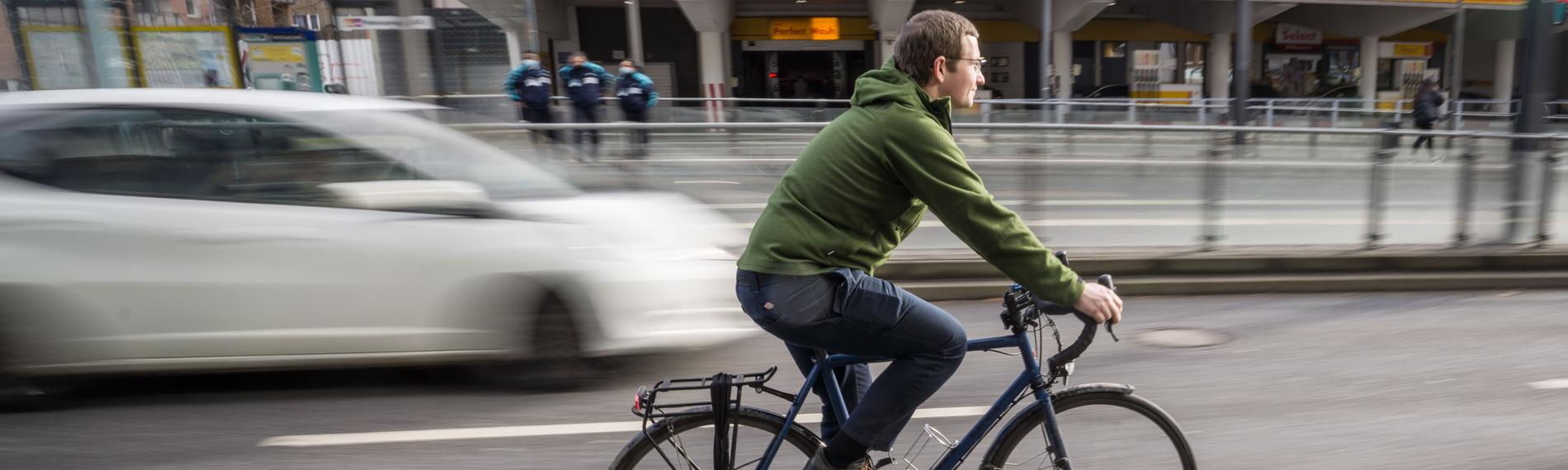 Fahrradfahrer auf Fahrradweg neben Autos,aufgenommen am 02.02.2022 in frankfurt am Main