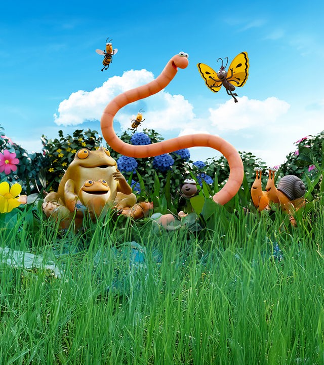 Mitten auf einer bunten Wiese, inmitten seiner Insektenfreunde befindet sich Superwurm. 