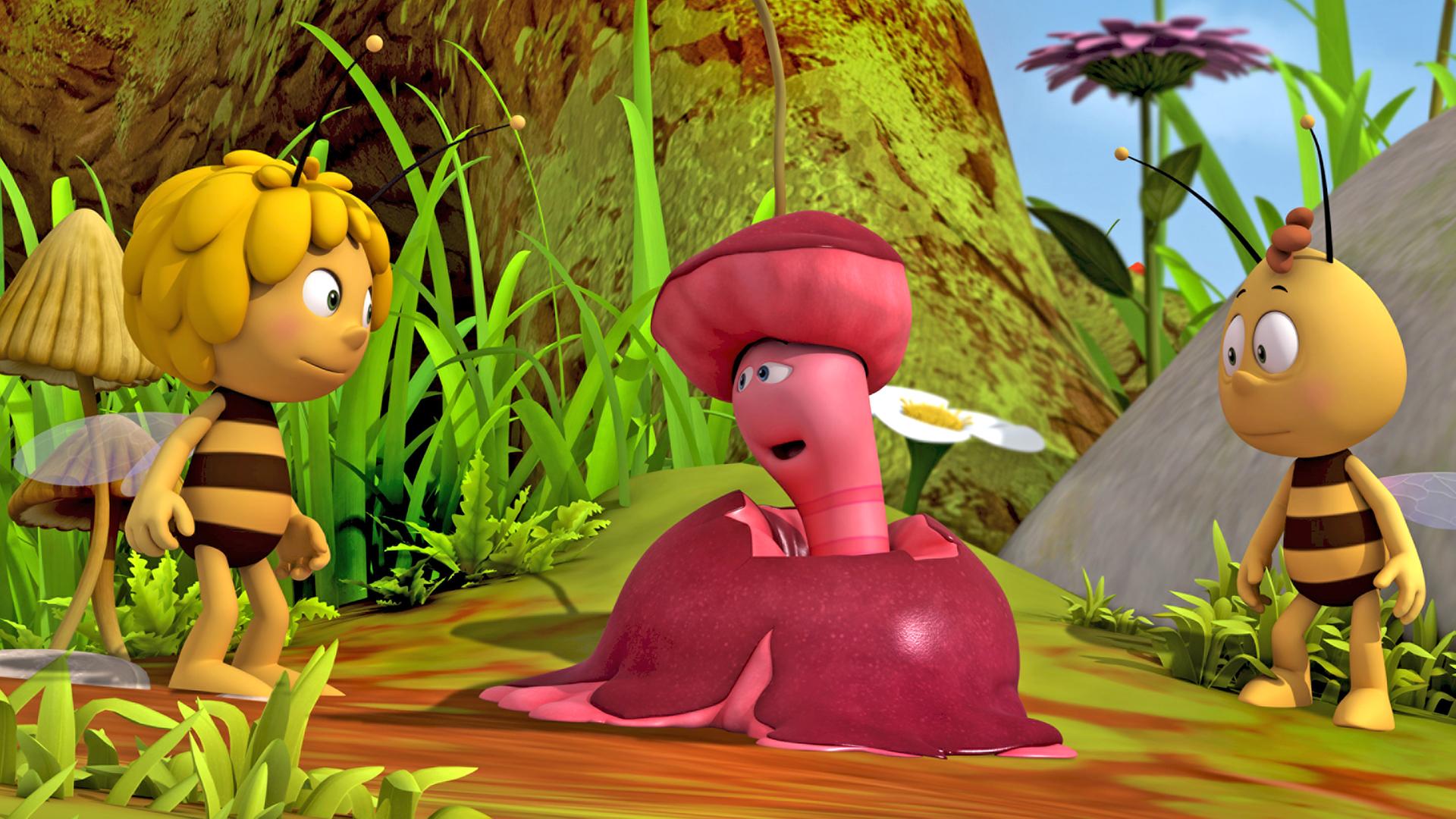 Wurm Max sitzt in einem zermatschten Apfel und unterhält sich mit Maja und Willi.