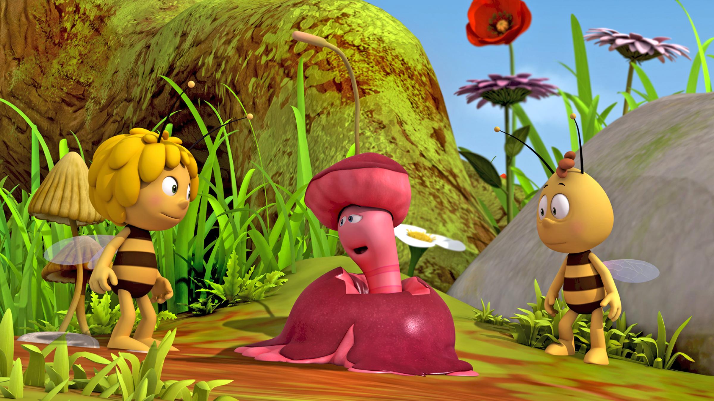 Wurm Max sitzt in einem zermatschten Apfel und unterhält sich mit Maja und Willi.