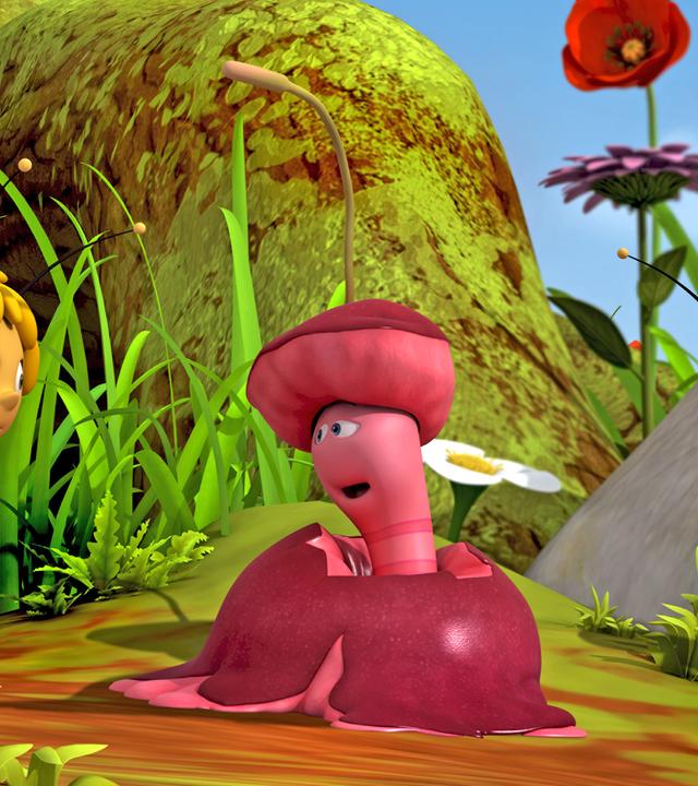 Wurm Max sitzt in einem zermatschten Apfel und unterhält sich mit Maja und Willi.