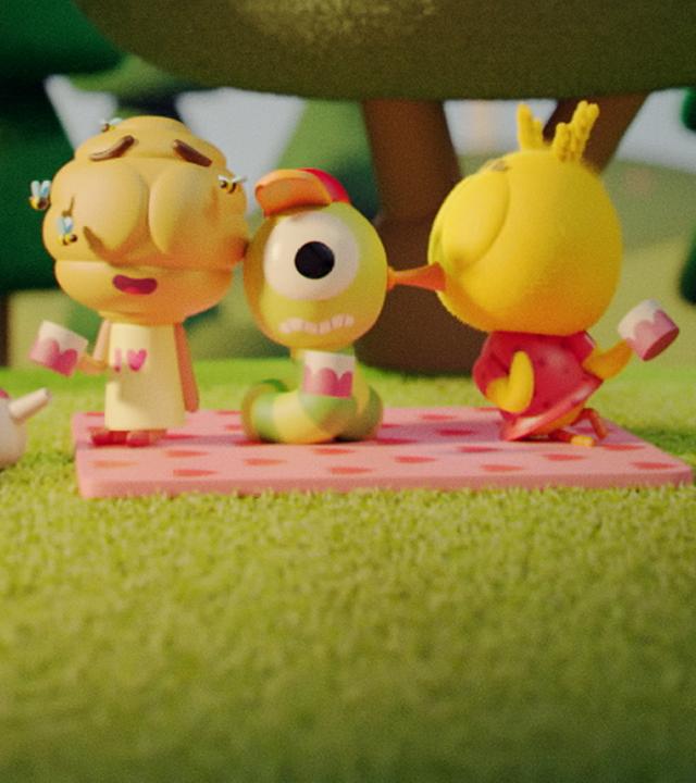 In der Mitte des Bildes sitzt Wurm Glitsch gemeinsam mit Flora, dem Bienenstock-Mädchen, und Küken Karla auf einer Wiese. Sie sitzen auf einer rosagetupften Picknickdecke. Karla küsst Glitsch auf die Wange. Flora sitzt auf der anderen Seite und hat ihre Augen schwärmend geschlossen. Neben Karla steht ein Radio auf der Wiese und neben Flora ein Körbchen und eine Teekanne. Im Hintergrund befinden sich große Bäume.