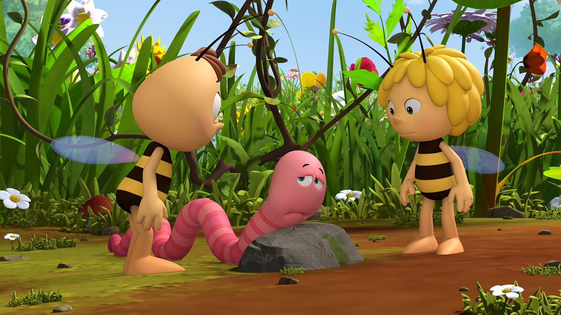 Max ist niedergeschlagen und lehnt über einem Stein. Maja und Willi wollen helfen.