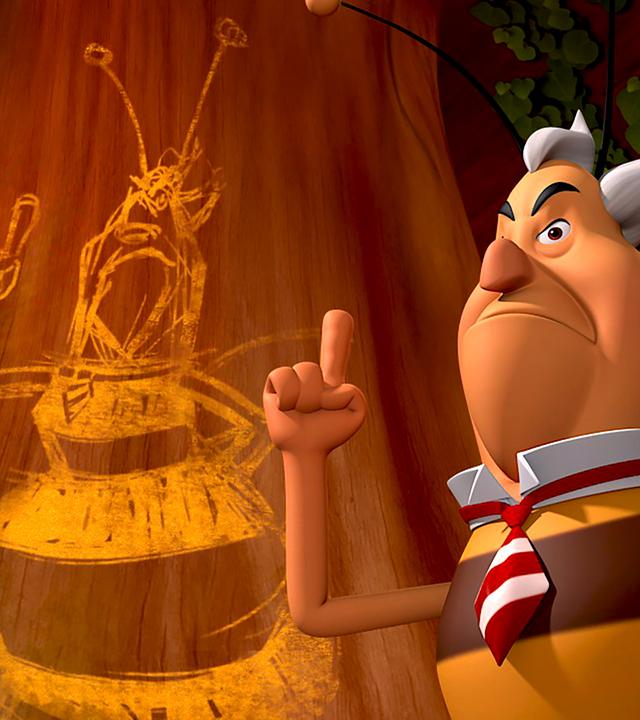 Richter Bienenwachs steht mit erhobenem Zeigefinger vor einer Schmiererei, die ihn selbst zeigt.