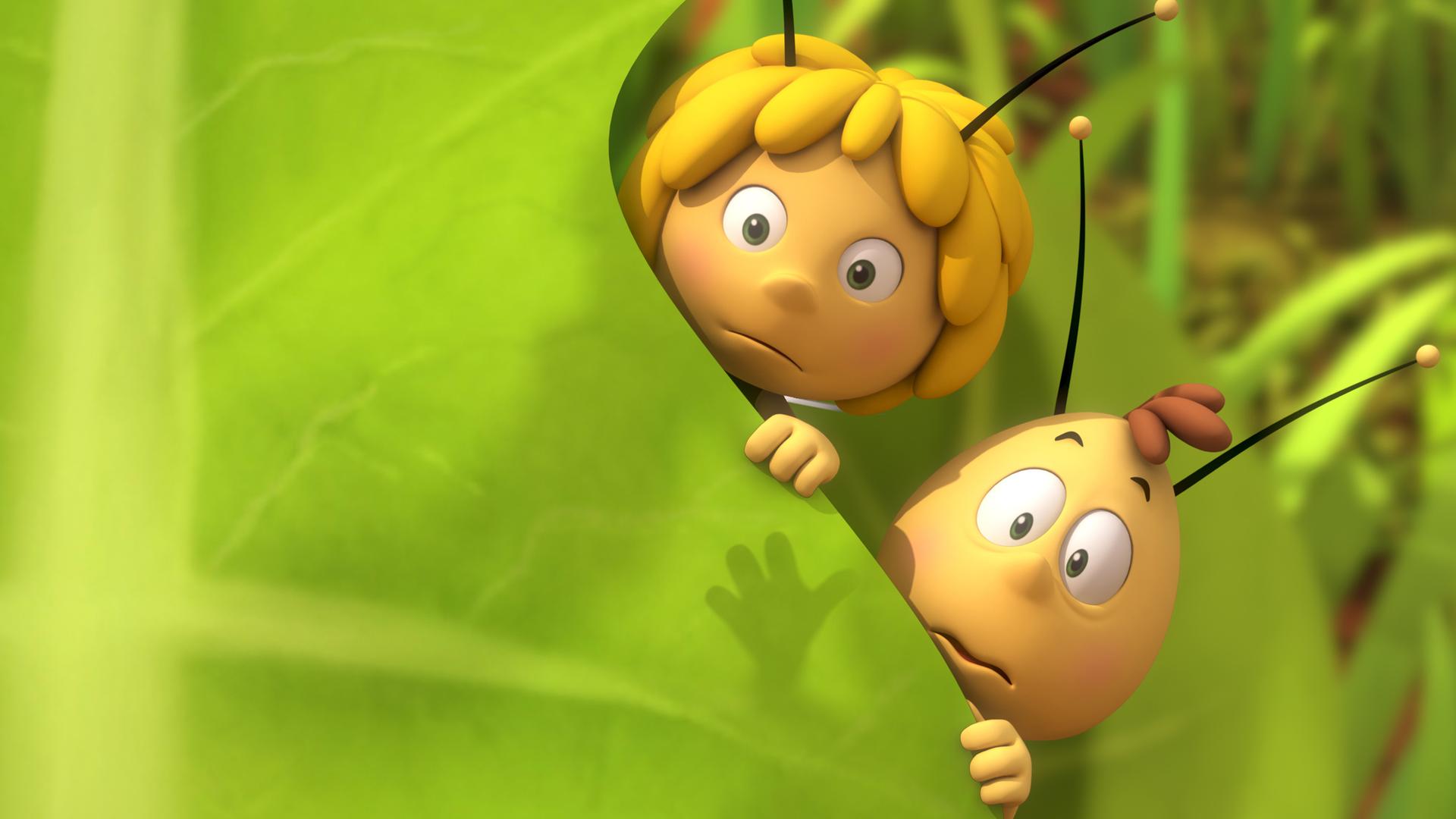 Maja und Willi verstecken sich hinter einem Blatt.