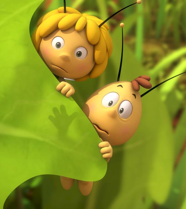 Maja und Willi verstecken sich hinter einem Blatt.