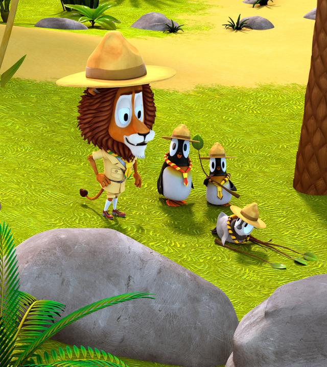 Lionel und die Pinguine tragen eine Pfadfinderuniform. Zwei der Pinguine stehen neben Lionel und vor ihnen liegt Kurti auf dem Boden.