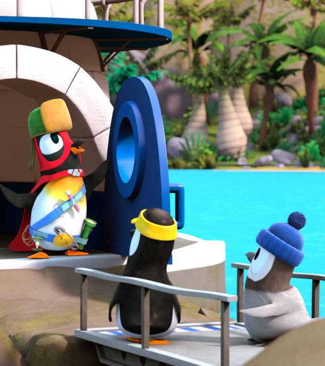 Jonathan steht als Superheld verkleidet vor den anderen Pinguinen.