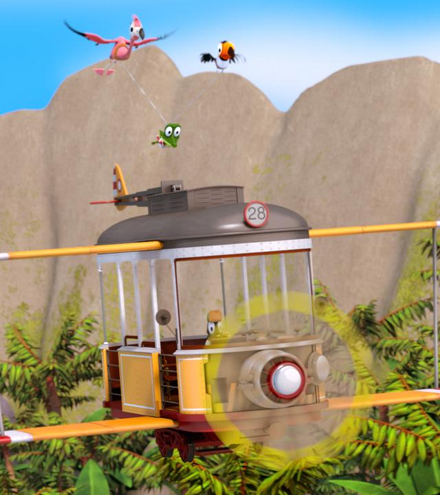 Vor einer Hügelkette fliegt ein Doppeldecker. Darüber fliegen ein Flamingo und ein Tukan, die ein Seil im Schnabel haben. Daran hängt zwischen ihnen Krokodil Zacki.