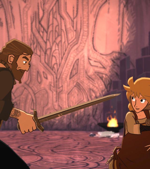 Dagmar und Alice stehen sich in der Höhle gegenüber. Beide haben ein Schwert in der Hand und duellieren sich. In der Höhle brennen links und rechts zwei Feuerschalen.