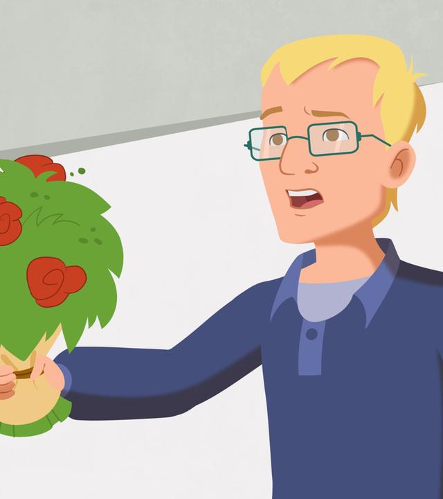 Taras Papa mit einem Blumenstrauß in der Hand.