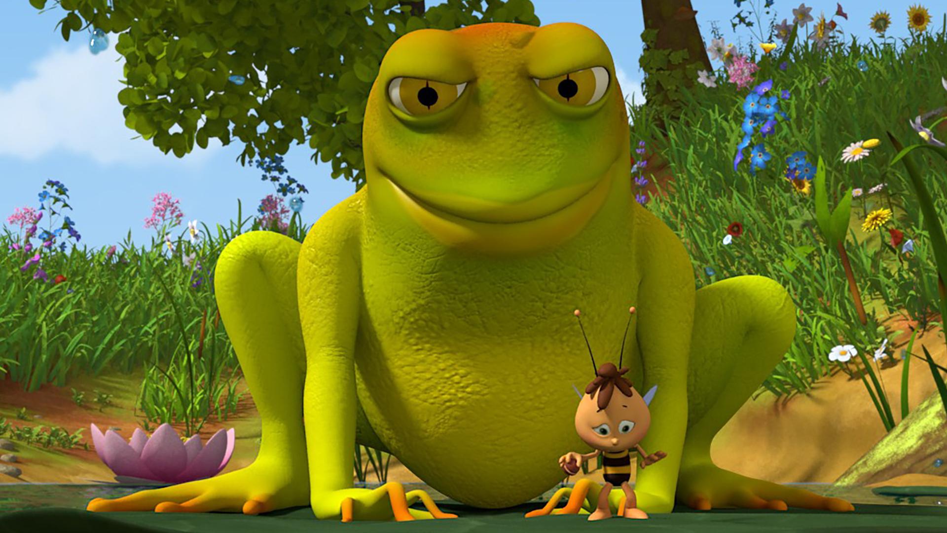 Willi steht auf einer Seerose. Hinter ihm lauert ein sehr großer Frosch.