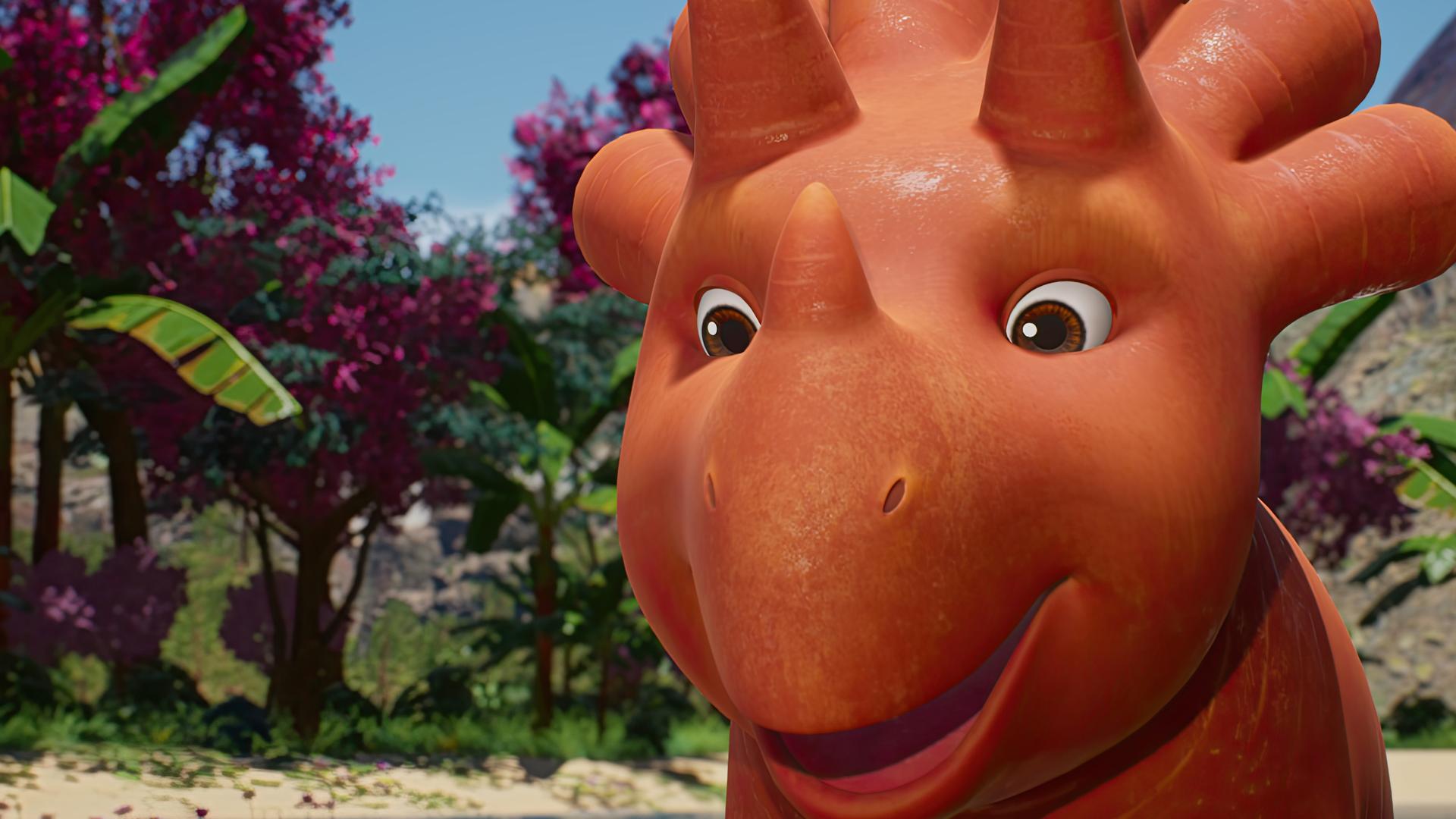 Ginger, ein Trikarottops-Mädchen, das aussieht wie eine Mischung aus Karotte und Nashorn, steht freudestrahlend vor Bananenstauden und im Hintergrund ist ein Vulkan zu sehen.