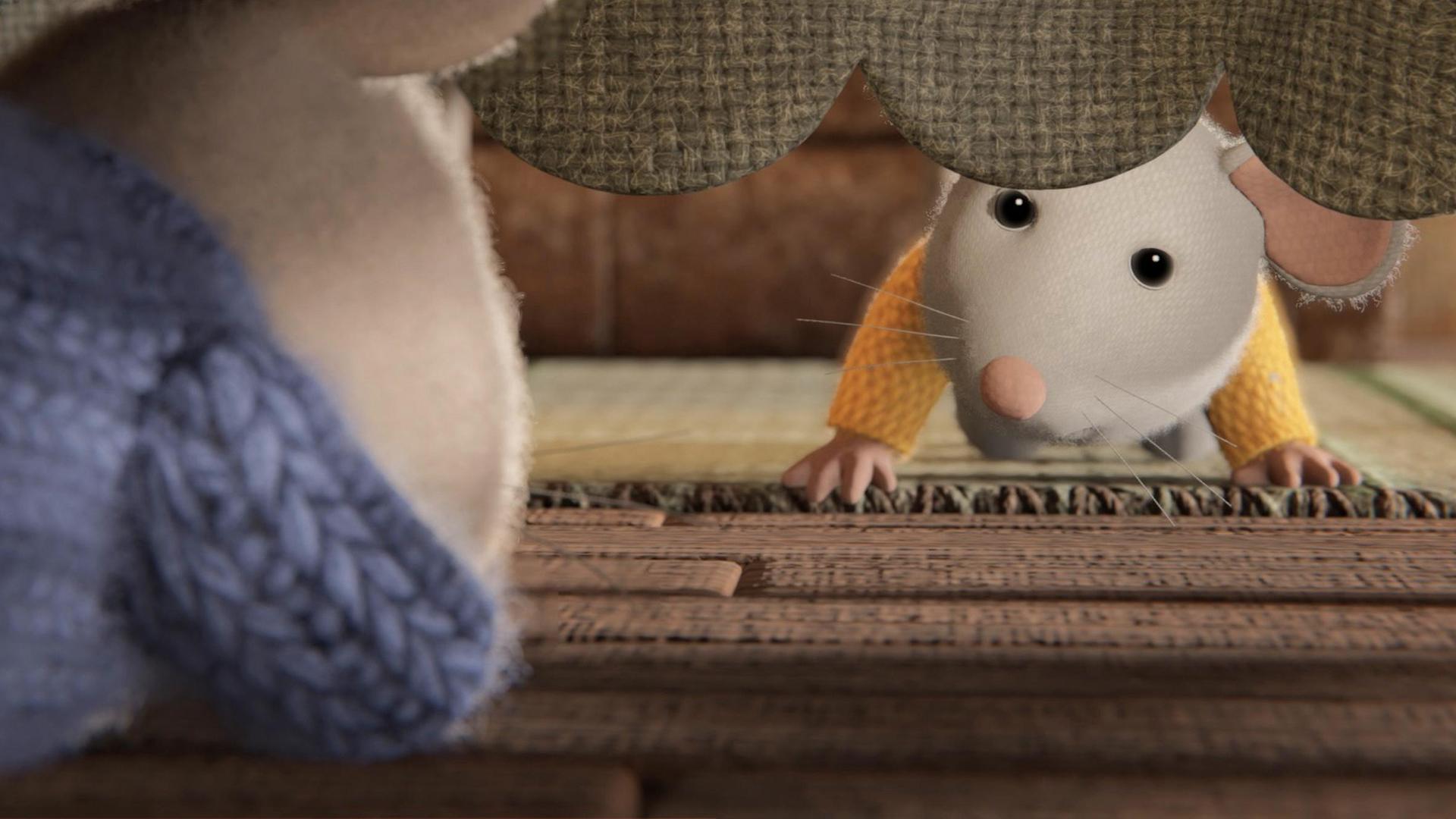 Sam liegt bäuchlings unter einem Tisch und schaut zu Ben, der unter dem herunterhängenden Tischtuch zu Sam durchlugt. Auf dem Boden liegt ein Teppich.