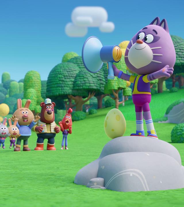 Auf einem Stein stehen etwas erhöht Holly, die lilafarbene Katze und ihr Freund Sascha, das gelbe Ei. Sie hat ein Megafon in der Hand und scheint etwas anzukündigen. Im Hintergrund jubeln die Bewohner von Wiesenwald - wir sehen sieben kleine Häschen, ihren Papa Rüdi, den Bär Bernhard und das Huhn Cherry. Sie stehen auf einer großen Wiese, um sie herum viele Bäume und Sträucher.