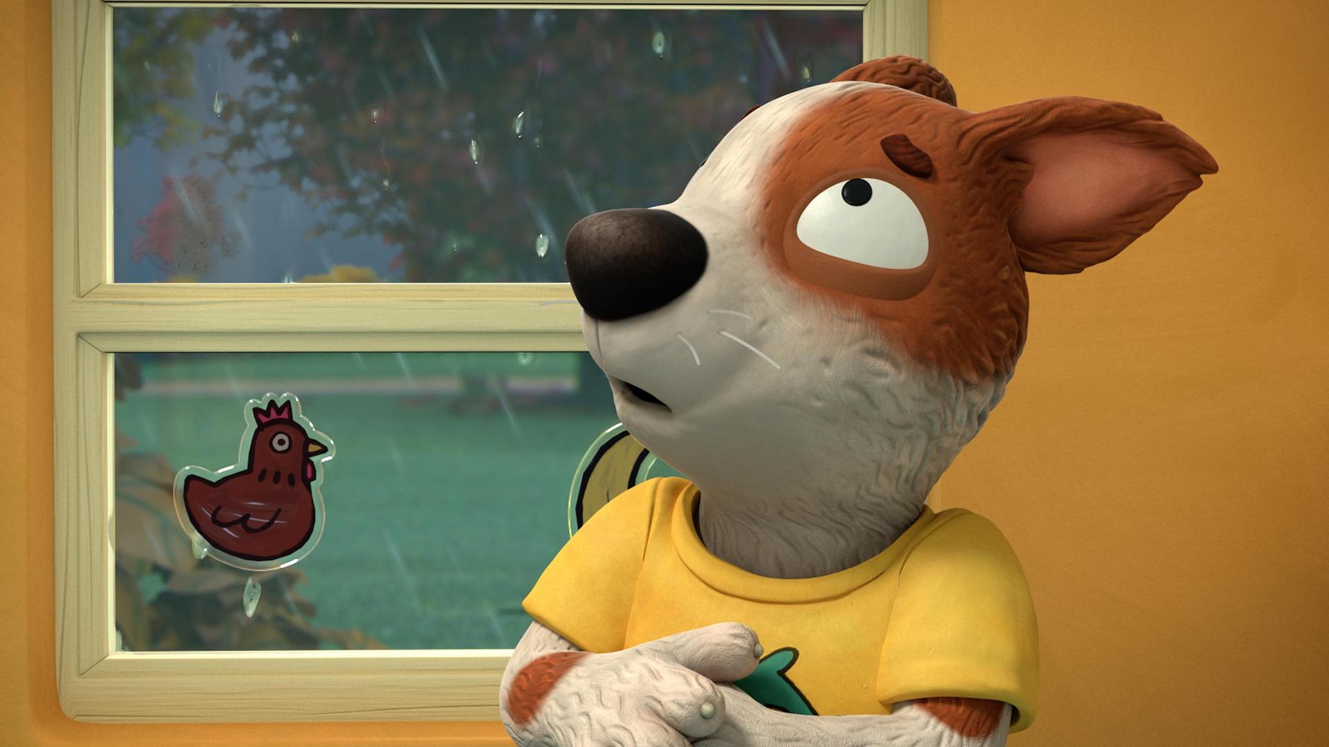 Der Hund Zac fürchtet sich. Er hat seine Ohren nach hinten gelegt und schaut sehr verängstigt aus. Der Blick aus dem Fenster zeigt dunkle Wolken und starker Regen, der gegen die Scheibe prasselt. Auf dem Fenster ist ein Aufkleber in Form eines Huhns geklebt.